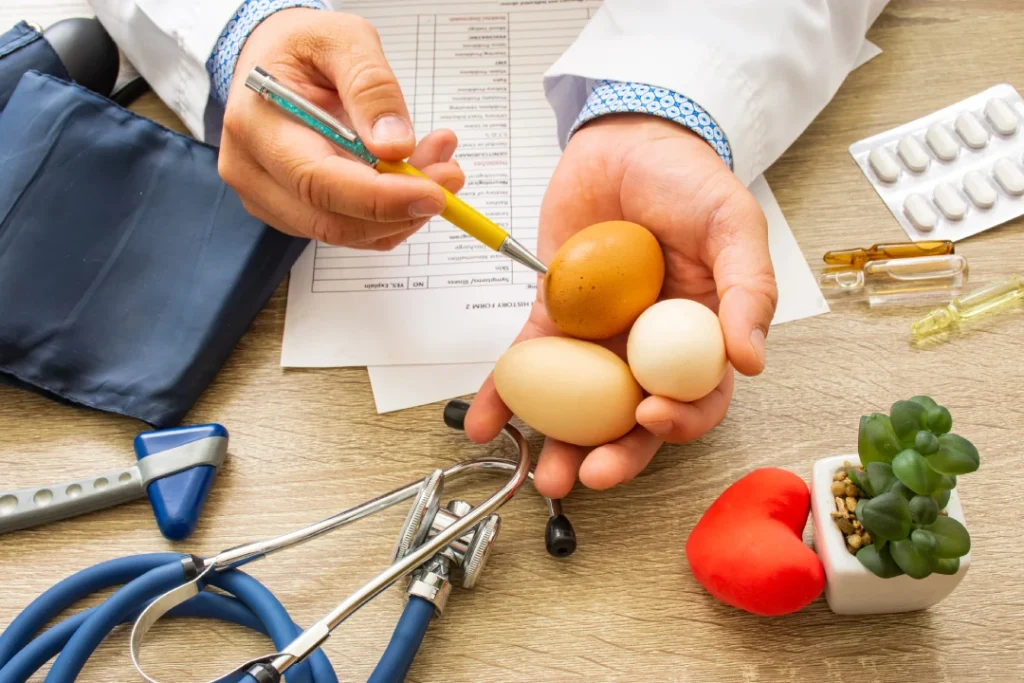 Weight loss doctor Houston discusses nutrition using colored eggs and medical tools in a clinical consultation setting.