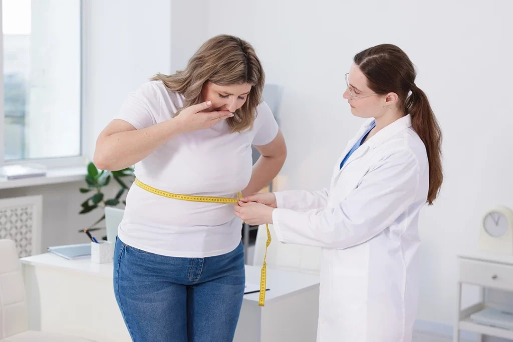 Concerned woman has waist measurement taken for semaglutide cost Houston by a professional in a clean clinic setting