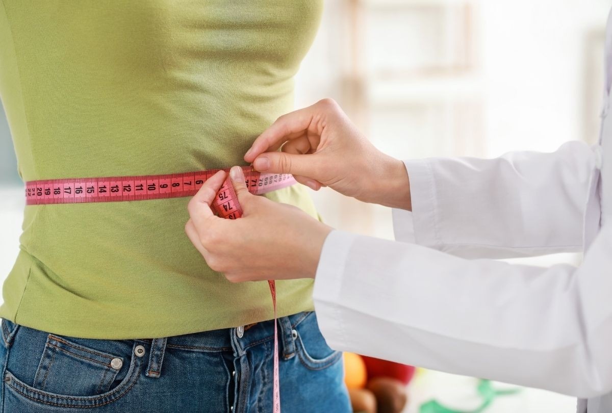 Weight loss clinic Houston—waistline measured during health check to track progress in personalized treatment.