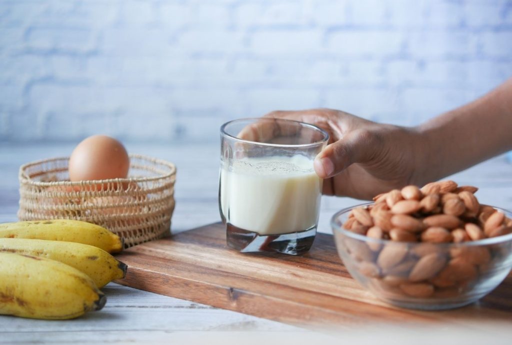 Bananas, almonds, egg and milk on table, balanced breakfast ideas from medical weight loss Houston nutrition program.