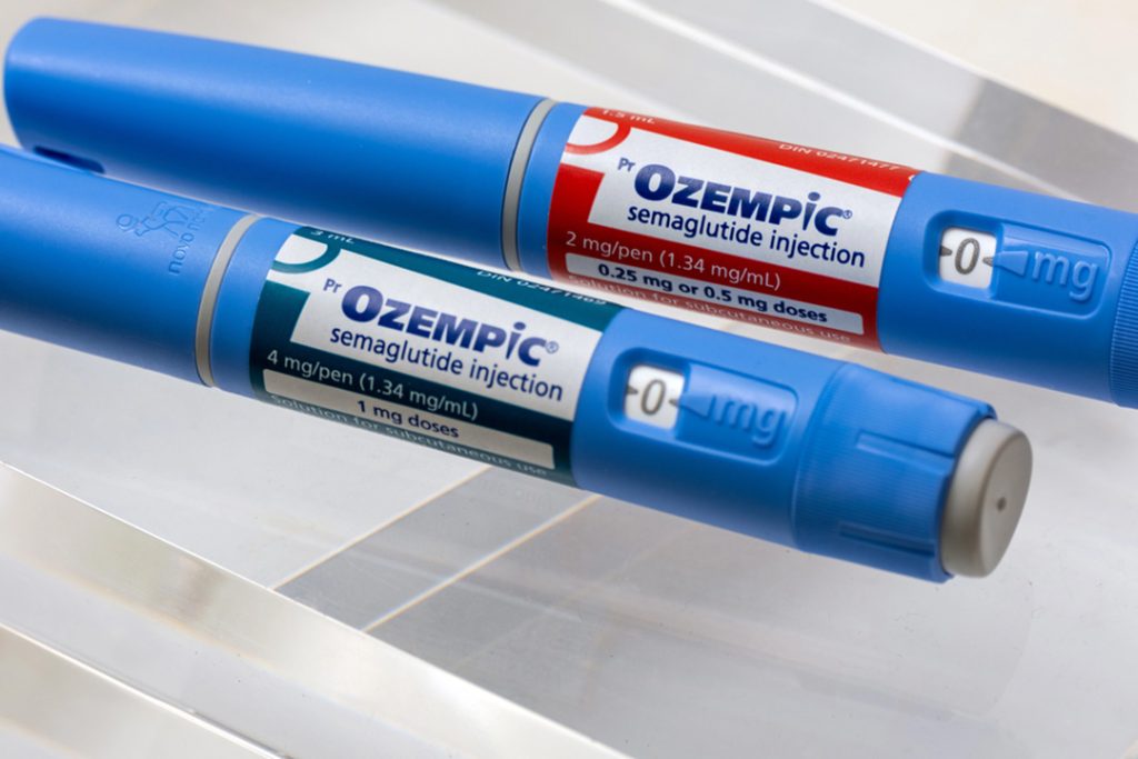 Ozempic semaglutide pens on desk at weight loss clinic Houston, dosage dial visible for diabetes and weight management therapy use.