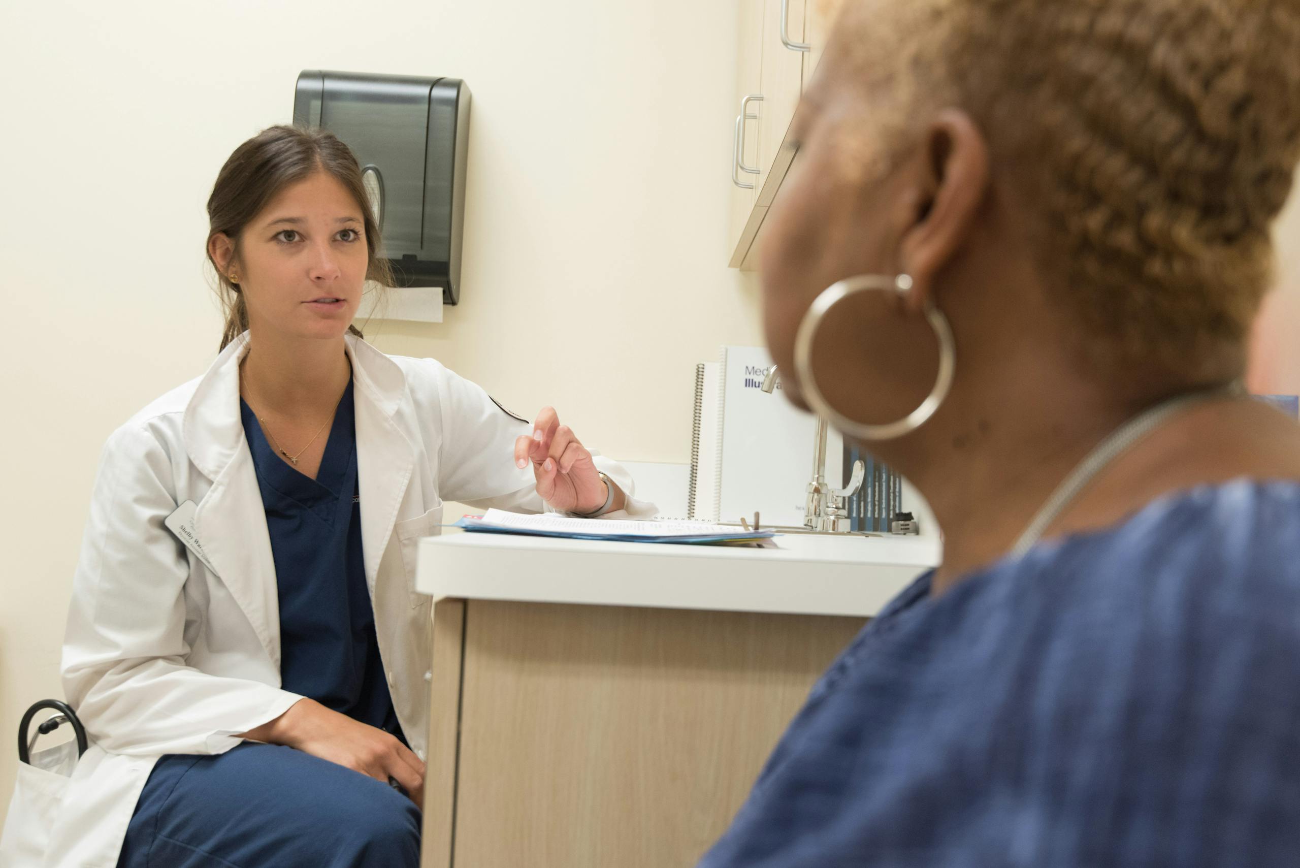 Doctor in consultation with patient at a medical clinic, discussing treatment options.