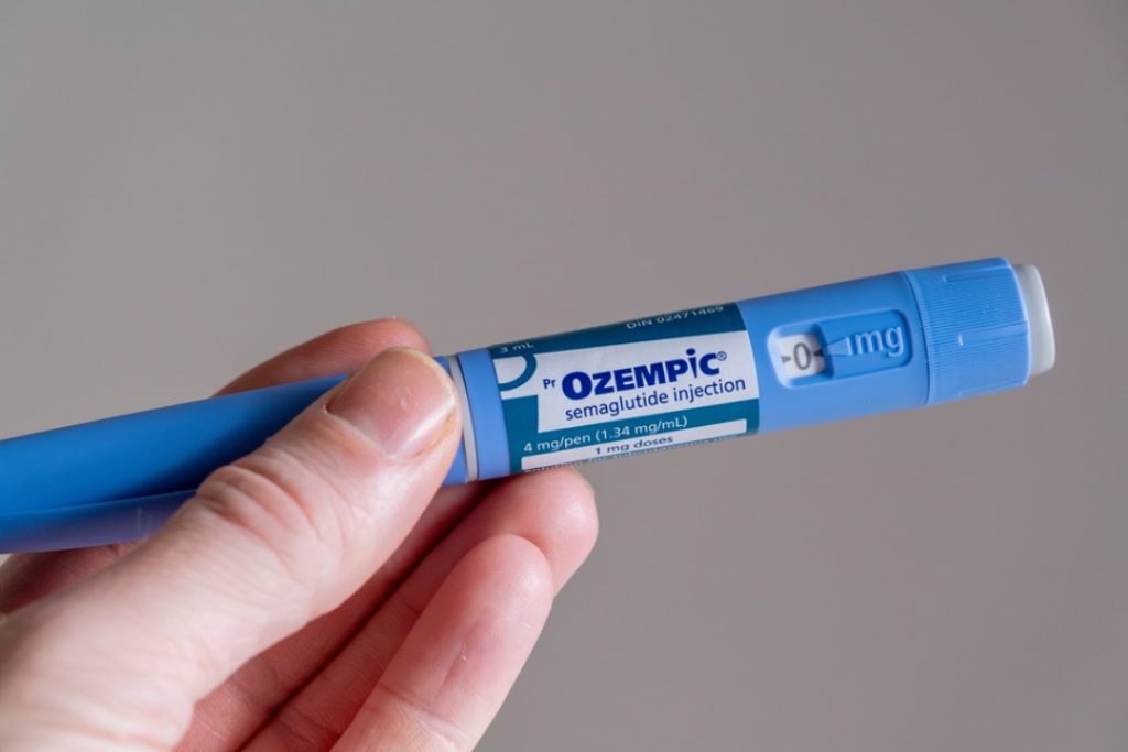 Hand holding an Ozempic semaglutide pen, a popular option for professional weight loss injections Houston patients use.