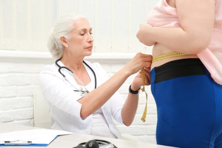 Medical professional measuring progress for a patient starting a program for weight loss injections Houston clinics offer.
