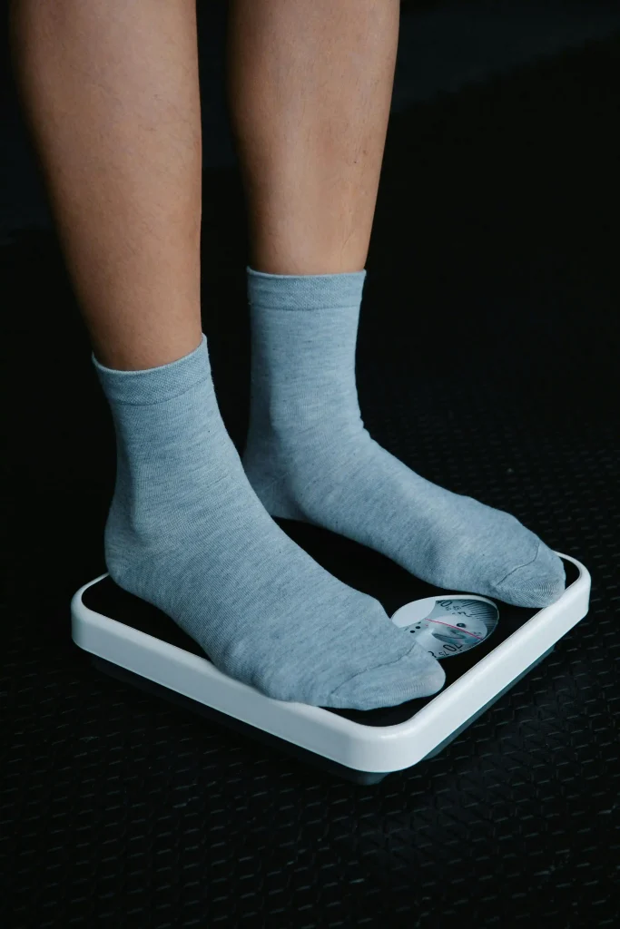 Close up of feet on a home scale to monitor progress while participating in a NewShape Weight Loss Clinic program.