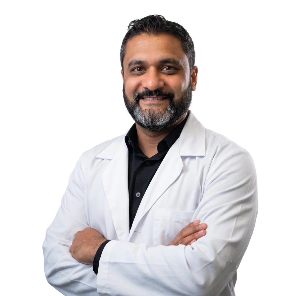 Professional portrait of a smiling male medical doctor in a white lab coat with crossed arms for healthcare blog